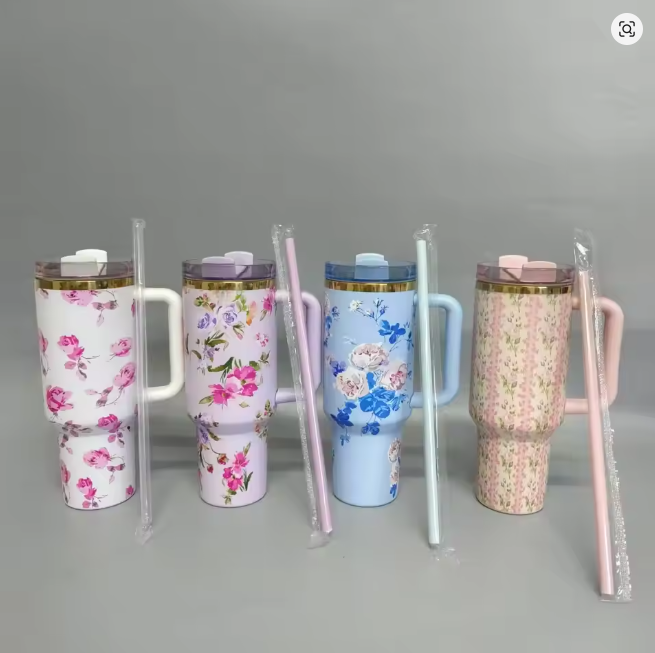 Four floral-themed tumblers with handles 