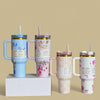 Four floral-patterned tumblers