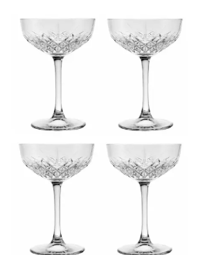 Four crystal cocktail glasses on a white background