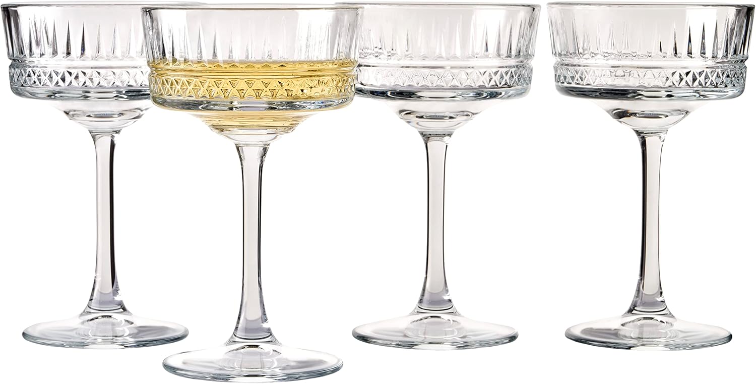 Set of four clear glass cocktail glasses on a white background