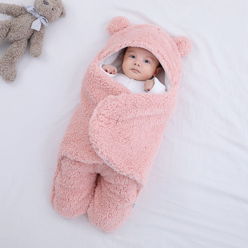 Light pink baby wrap blanket, soft and cozy for newborns.