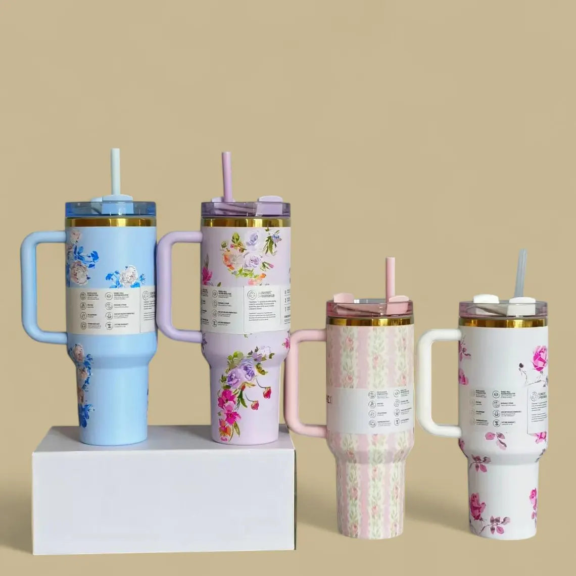 Four floral-themed tumblers with handles 