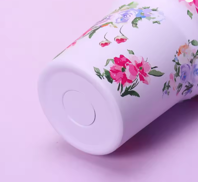 White container with floral design on a pink background