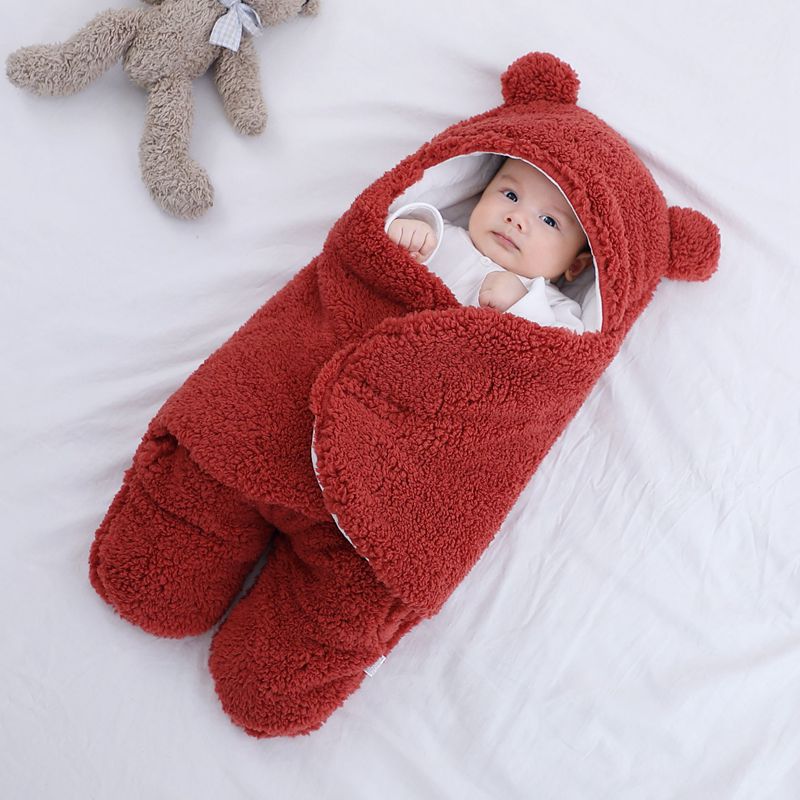 Newborn red wrap, perfect for baby warmth and security.