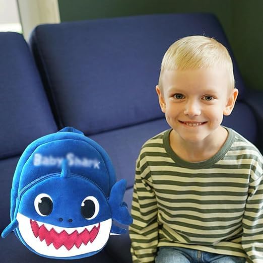 Child with a blue shark-shaped backpack 