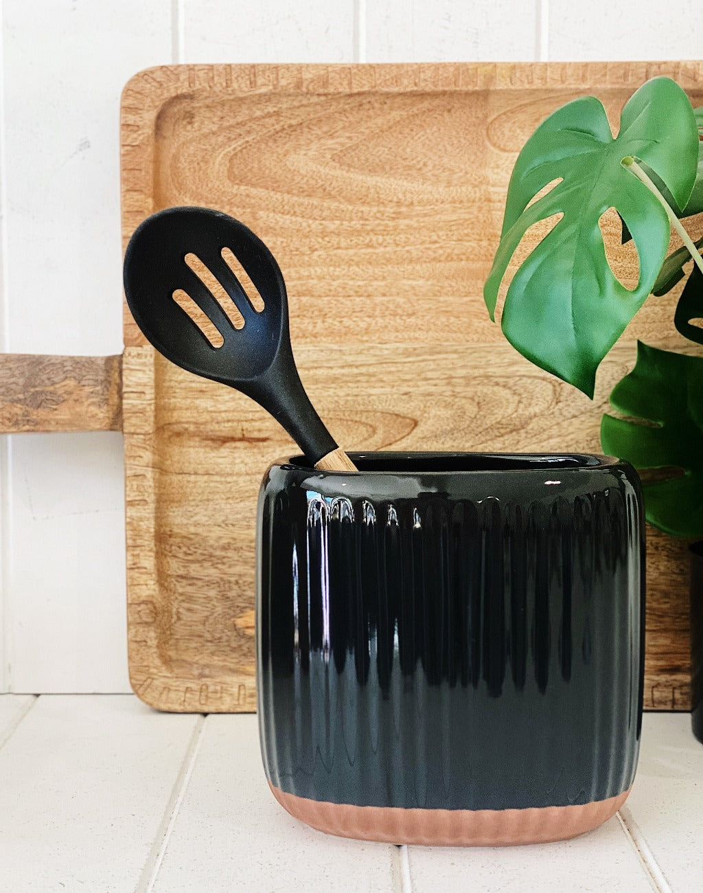 Created from stoneware with a soft organic form and hand carved rib texture is our Amana Utensil Holder. With a distinctive glossy black glaze and matte faux terracotta base, this 16.5x11x16cm utensil holder is ideal for keeping your bench top tidy.| Bliss Gifts &amp; Homewares | Unit 8, 259 Princes Hwy Ulladulla | South Coast NSW | Online Retail Gift &amp; Homeware Shopping | 0427795959, 44541523
