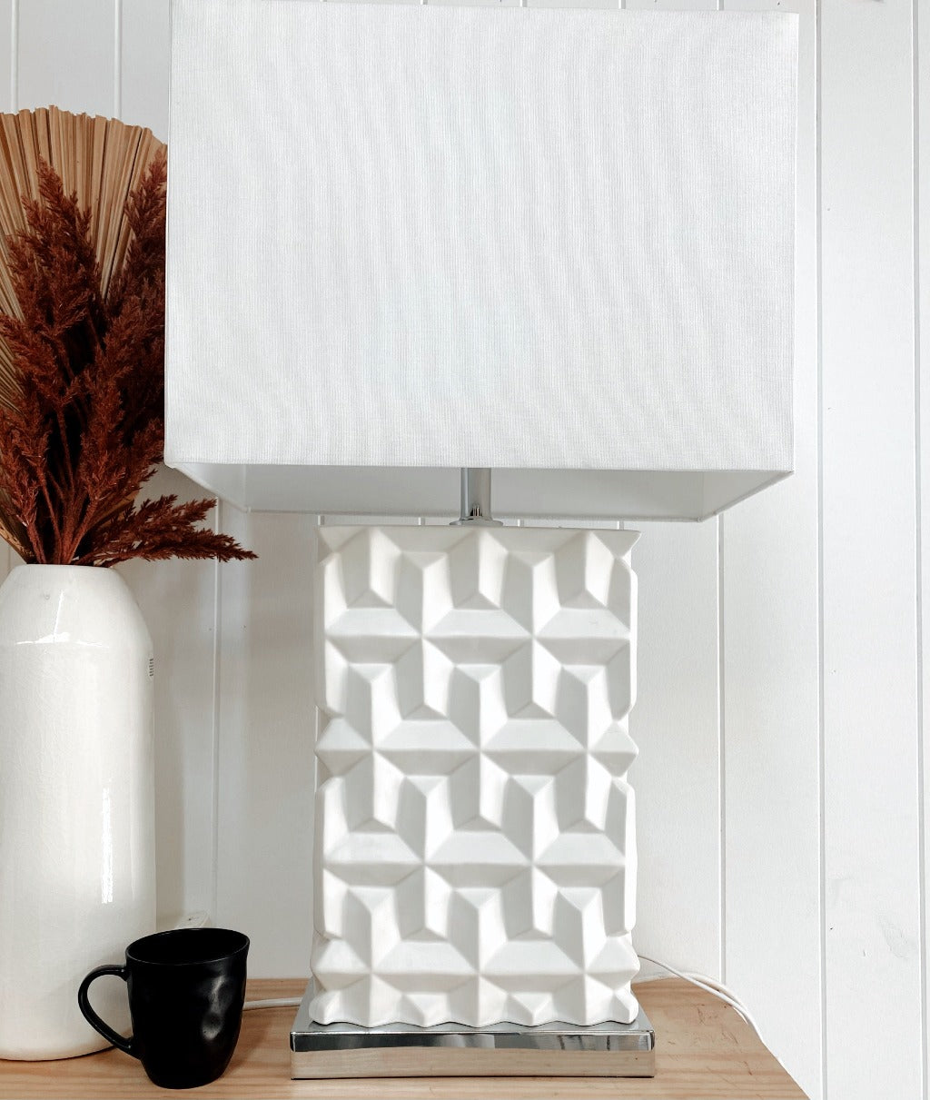 Our white Colada Table Lamp is the lighting you need to set the mood for reading, studying, or spending just a minute on the couch before you head to bed. With a white textured ceramic base, complimented by a fabric shade. 43x77cm.| Bliss Gifts & Homewares | Unit 8, 259 Princes Hwy Ulladulla | South Coast NSW | Online Retail Gift & Homeware Shopping | 0427795959, 44541523