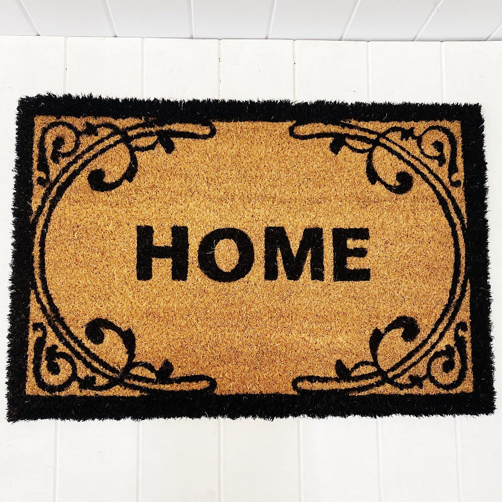 Our gorgeous Filigree Home Door Mat is the perfect way to create a luxe feel to your home before your guests even step foot inside. - 60 x 40cm - Black "Home" sign surrounded by a beautiful black filigree design on a natural background - Made from Natural coir fibres - PVC backing | Bliss Gifts & Homewares | Unit 8, 259 Princes Hwy Ulladulla | South Coast NSW | Online Retail Gift & Homeware Shopping | 0427795959, 44541523