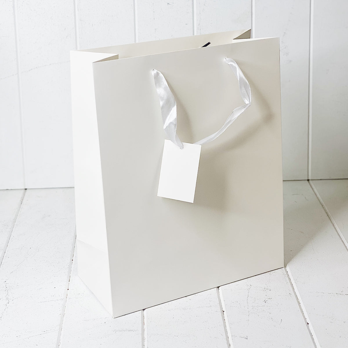 Give your loved ones a gift with our Matte White Gift Bag in Large. Available in multiple sizes to fit your gift perfectly. 26x32x12cm| Bliss Gifts &amp; Homewares | Unit 8, 259 Princes Hwy Ulladulla | South Coast NSW | Online Retail Gift &amp; Homeware Shopping | 0427795959, 44541523