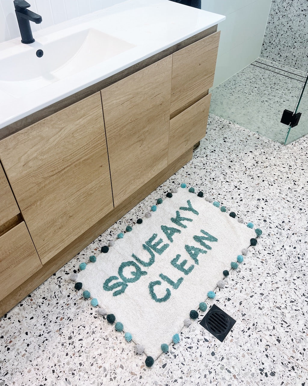 Our Squeaky Clean Bathmat - 50 x 80cm will bring a playful style and a pop of colour to your bathroom. Featuring a fun worded design with pom poms, this bathmat also adds texture to your bathroom or ensuite.| Bliss Gifts &amp; Homewares | Unit 8, 259 Princes Hwy Ulladulla | South Coast NSW | Online Retail Gift &amp; Homeware Shopping | 0427795959, 44541523