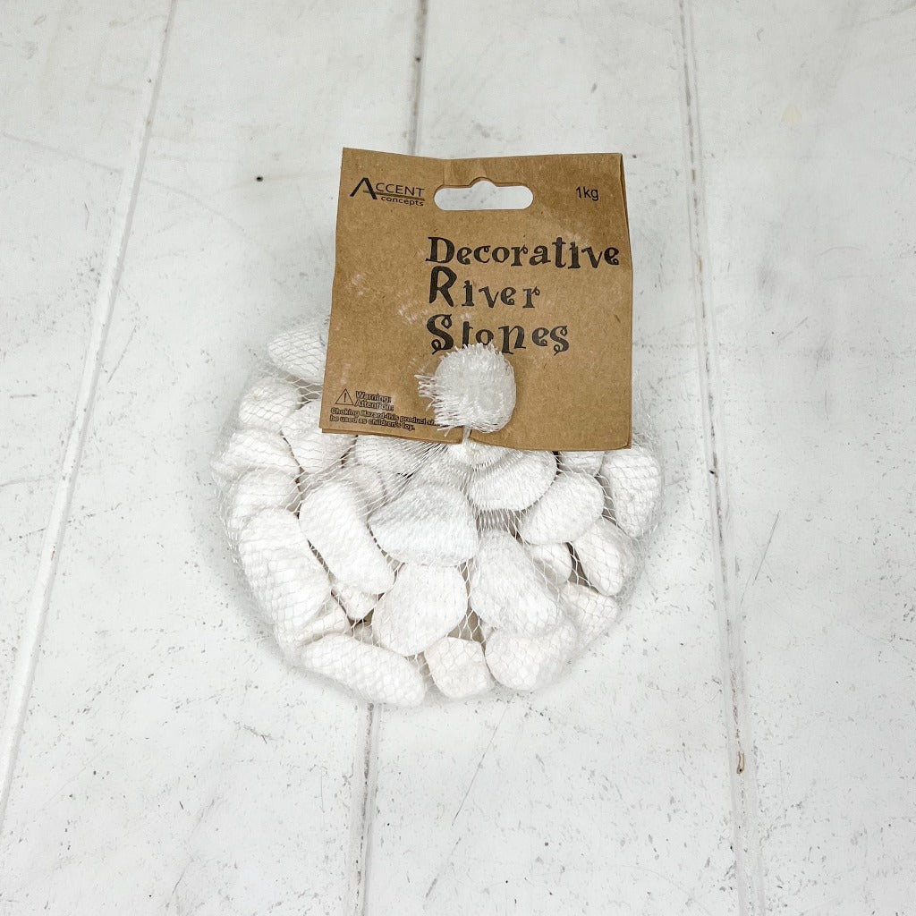 Decorate your faux flower vases, shallow platters, potted plants and much more with our washed White Decorative River Pebbles. Bringing a natural theme to your home decor, whatever you display is sure to look crisp and creative. Comes in a 1kg bag. | Bliss Gifts & Homewares | Unit 8, 259 Princes Hwy Ulladulla | South Coast NSW | Online Retail Gift & Homeware Shopping | 0427795959, 44541523